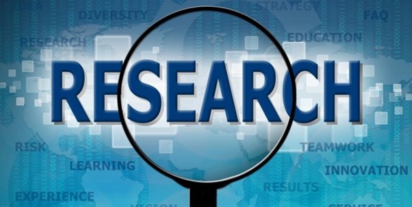 A graphic image of a magnifying glass, highlighting the word "Research".